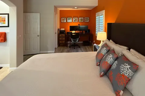 a bathroom with double vanity and a mirror