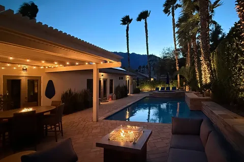 a view of swimming pool with a yard and trees