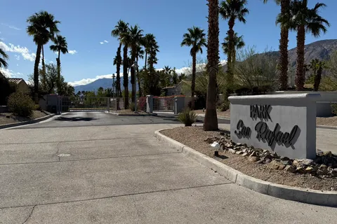 a view of a street with cars parked