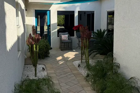 a view of a house with a backyard