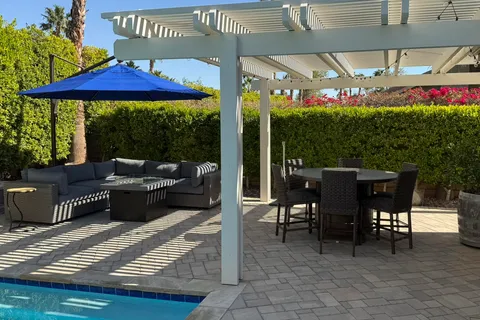 a view of a patio with table and chairs potted plants with wooden floor