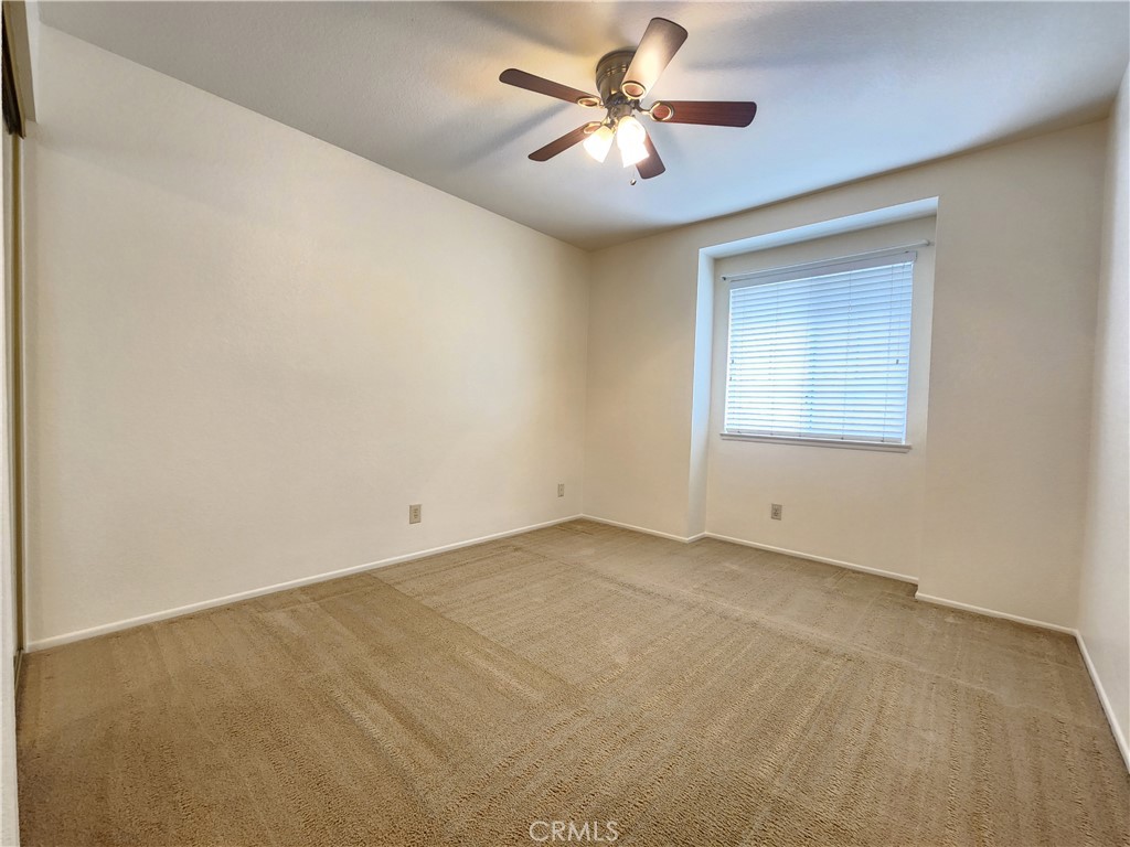 21029 Northview Drive Walnut, CA 91789 - Photo 18 of 22 an empty room with chandelier fan and windows