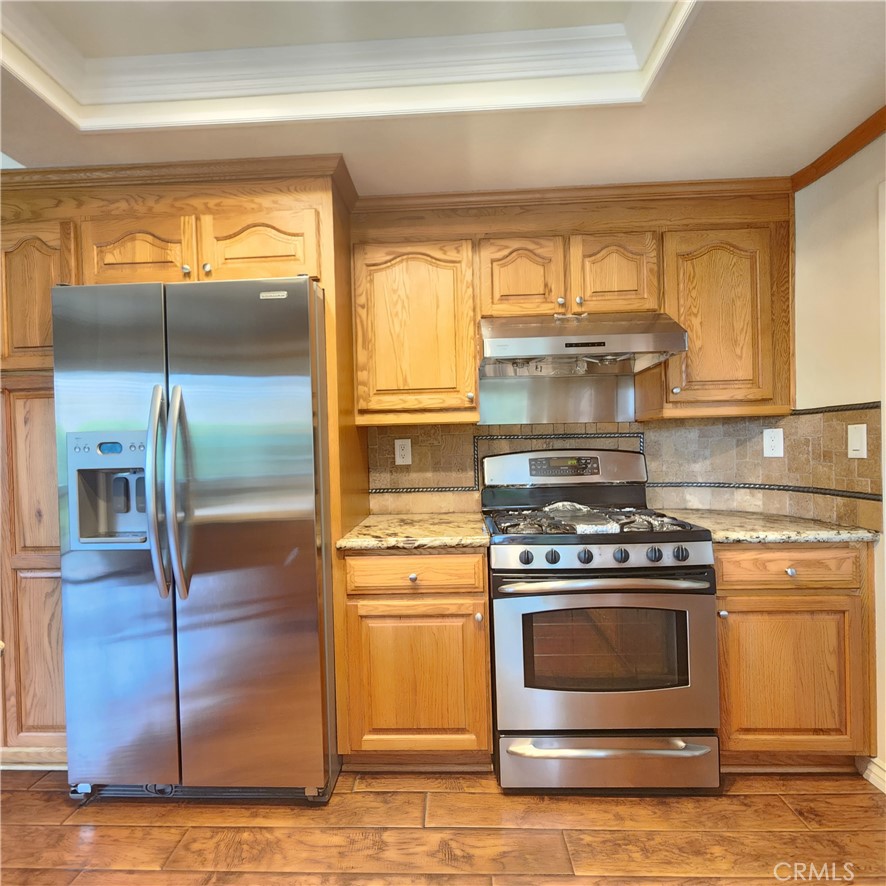21029 Northview Drive Walnut, CA 91789 - Photo 8 of 22 a kitchen with granite countertop a stove and a refrigerator