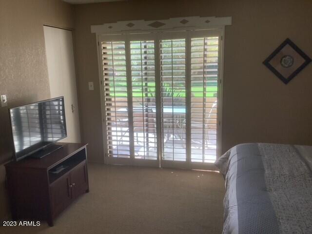 8649 East Royal Palm Road, Unit 104 Scottsdale, AZ 85258 - Photo 11 of 20 a living room with furniture and a flat screen tv