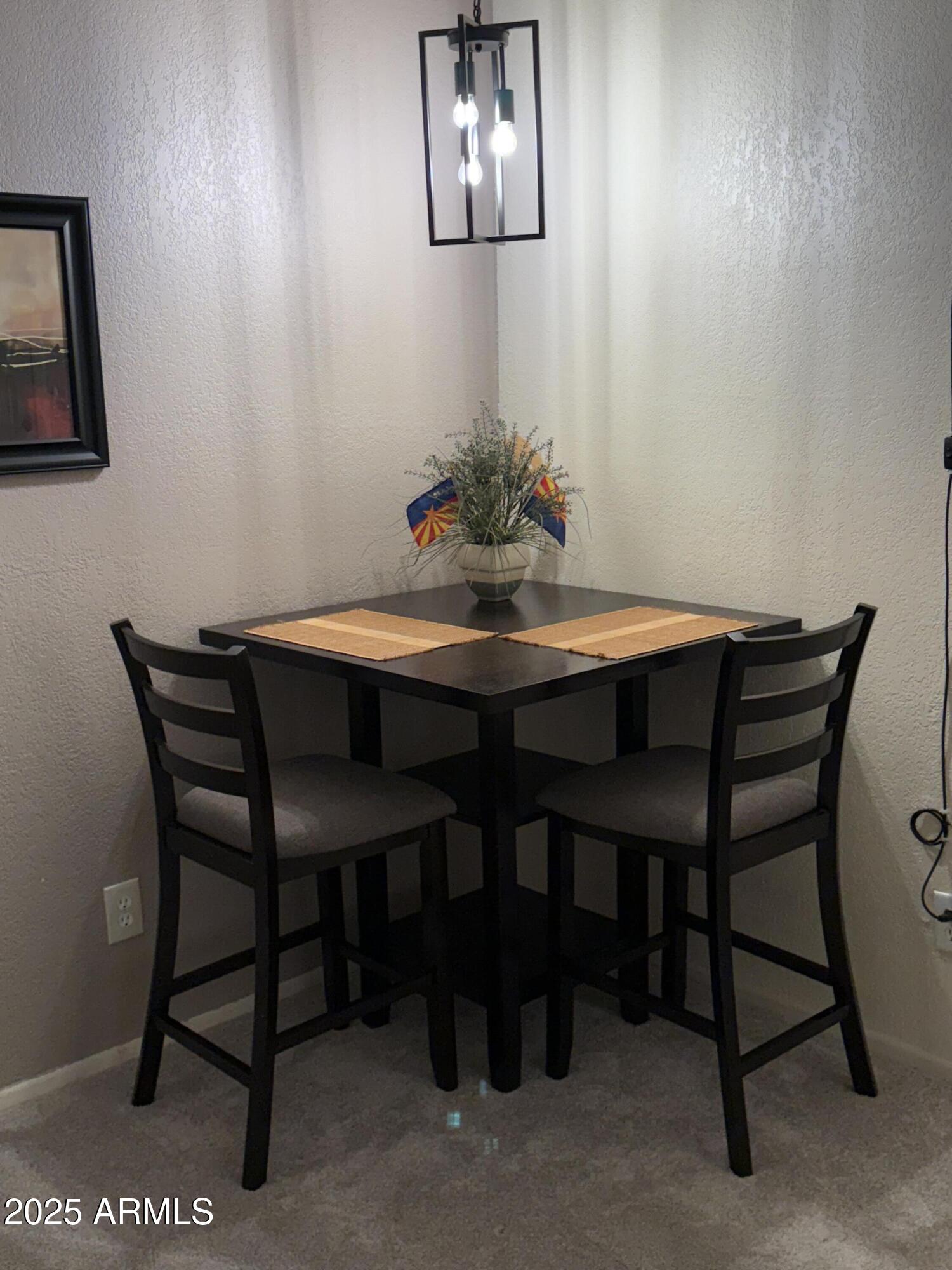 8649 East Royal Palm Road, Unit 104 Scottsdale, AZ 85258 - Photo 13 of 20 a view of a dining room with furniture and wooden floor