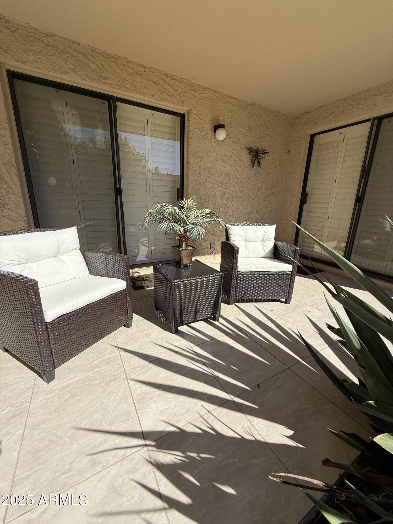8649 East Royal Palm Road, Unit 104 Scottsdale, AZ 85258 - Photo 14 of 20 a living room with couches and a flat screen tv