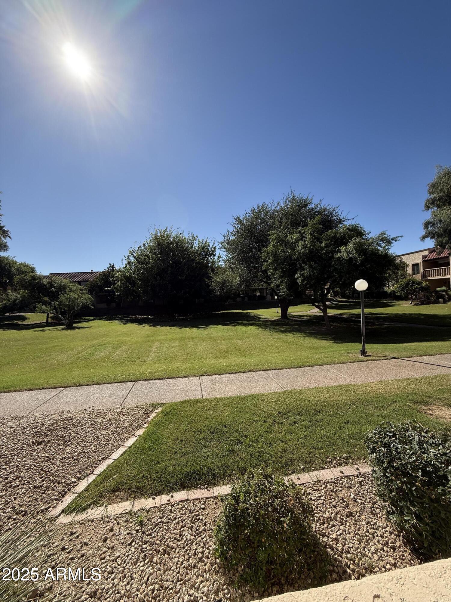 8649 East Royal Palm Road, Unit 104 Scottsdale, AZ 85258 - Photo 18 of 20 a view of a golf course with a lake