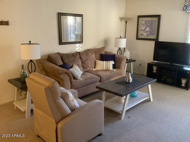 8649 East Royal Palm Road, Unit 104 Scottsdale, AZ 85258 - Photo 5 of 20 a living room with furniture and a flat screen tv