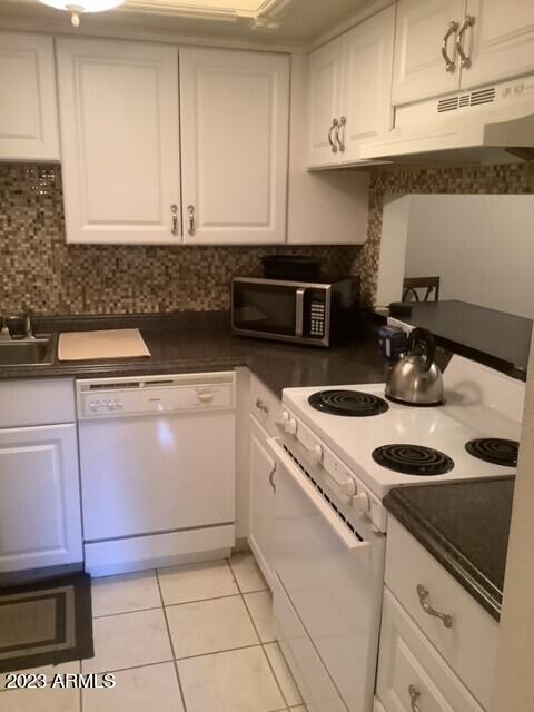 8649 East Royal Palm Road, Unit 104 Scottsdale, AZ 85258 - Photo 6 of 20 a kitchen with a sink and cabinets