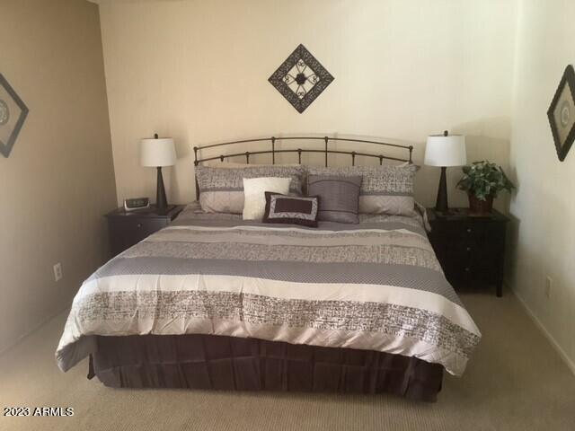 8649 East Royal Palm Road, Unit 104 Scottsdale, AZ 85258 - Photo 9 of 20 a bedroom with a bed and painting on the wall