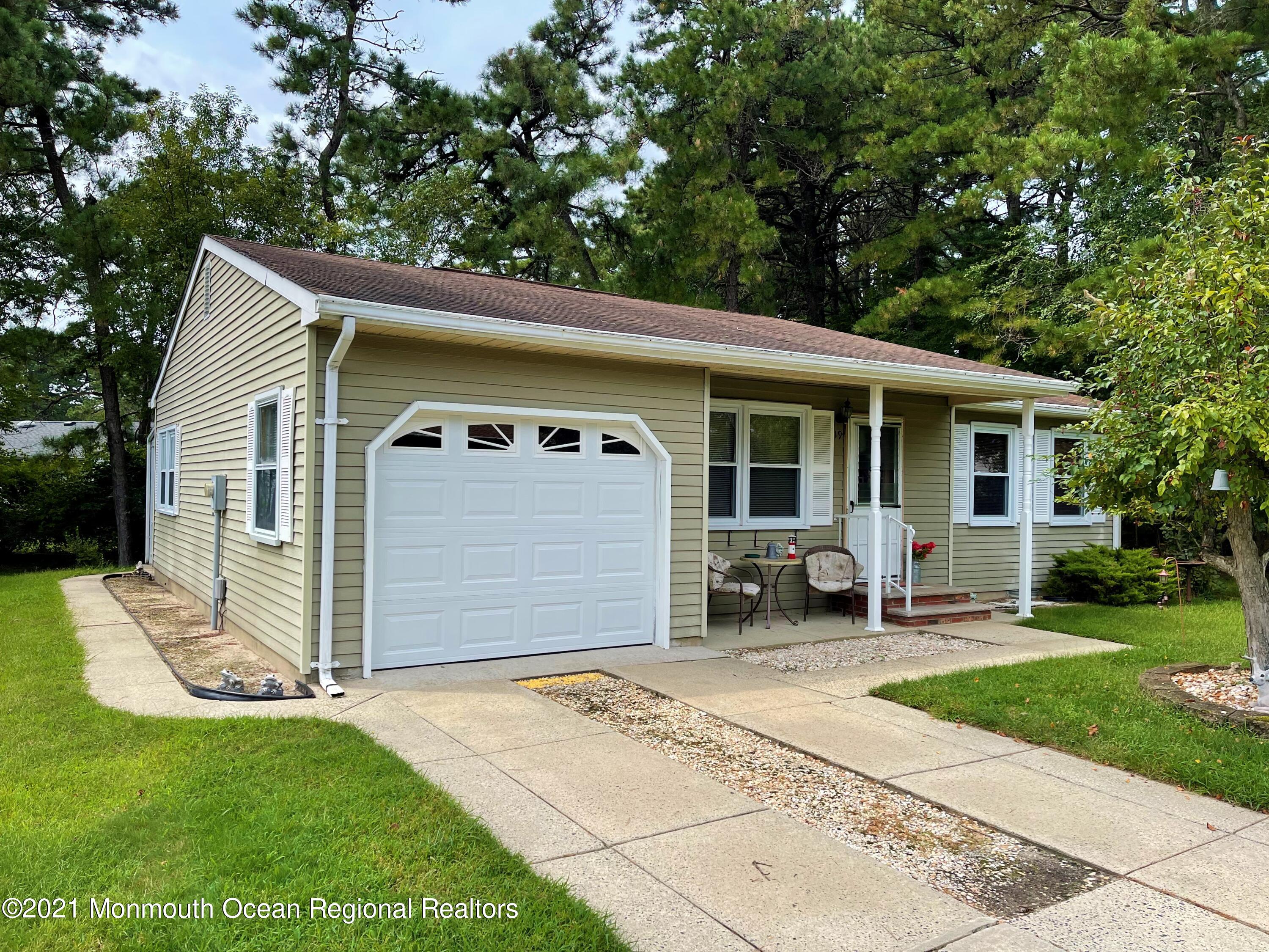 19 Augusta Road, Unit 73 Whiting, NJ 08759 - Photo 1 of 11 a front view of a house with a garden and porch