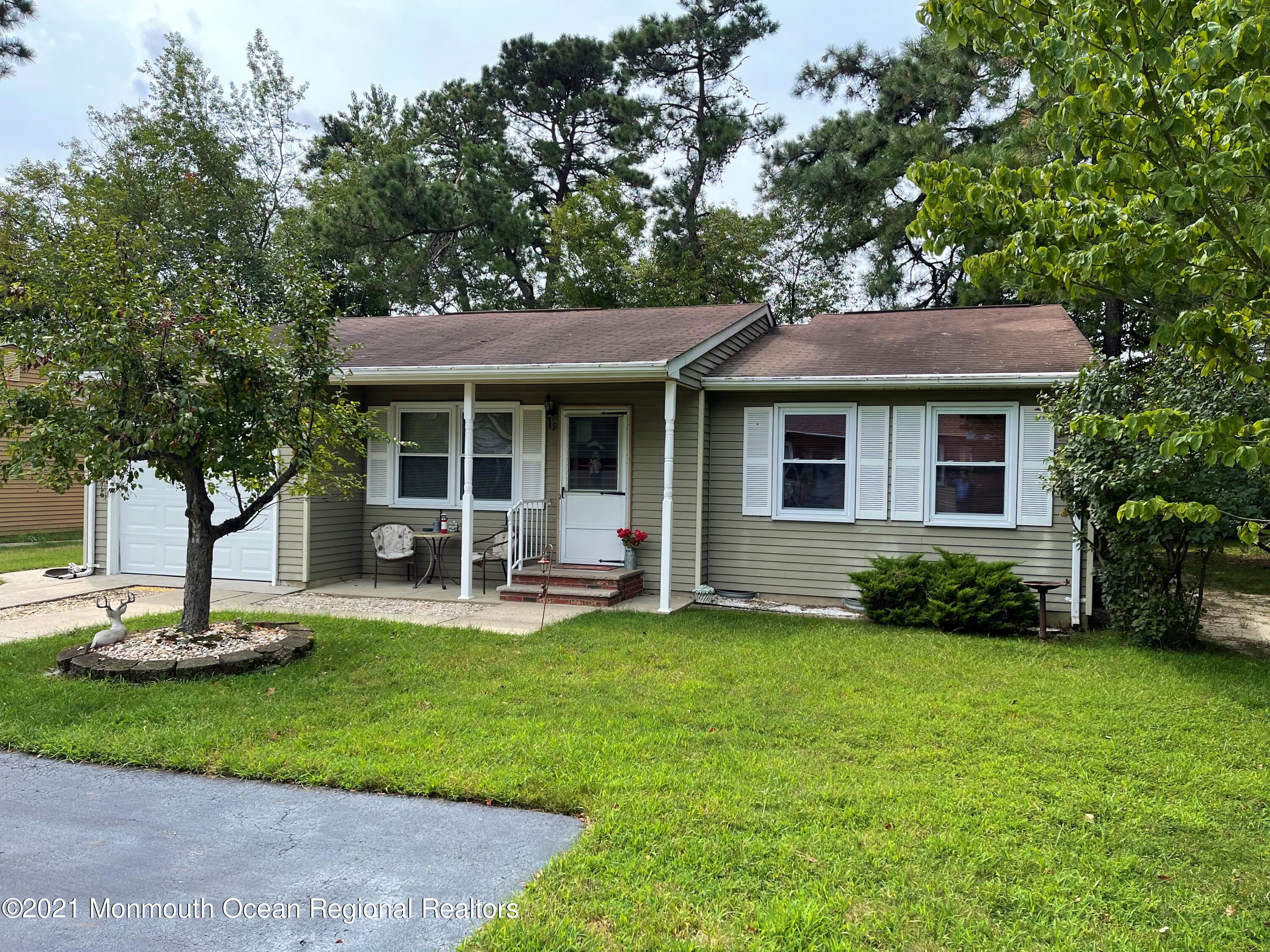 19 Augusta Road, Unit 73 Whiting, NJ 08759 - Photo 2 of 11 a view of a house with a yard porch and sitting area