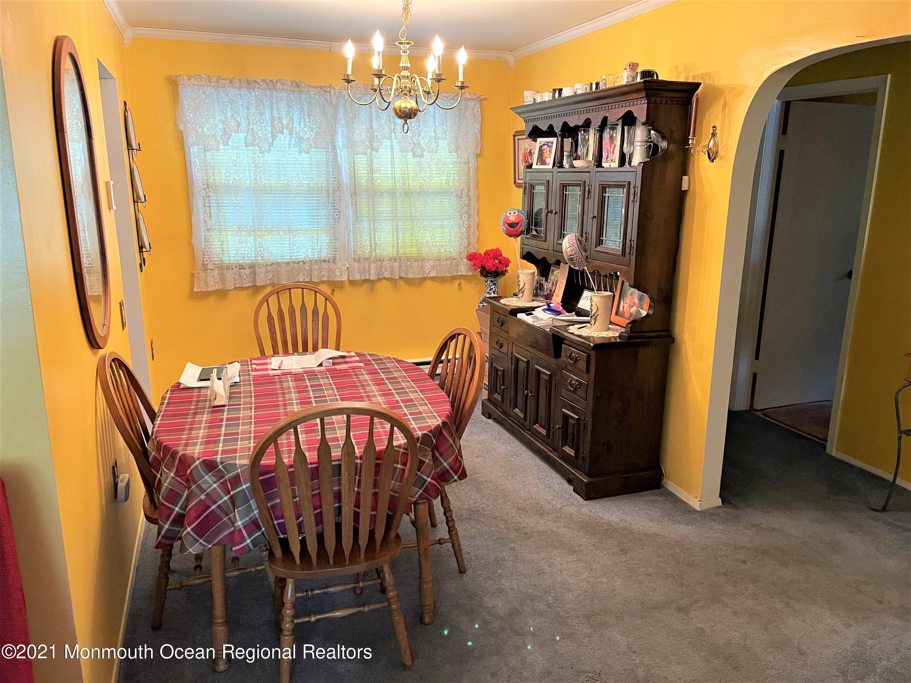 19 Augusta Road, Unit 73 Whiting, NJ 08759 - Photo 4 of 11 a view of a dining room with furniture and a chandelier