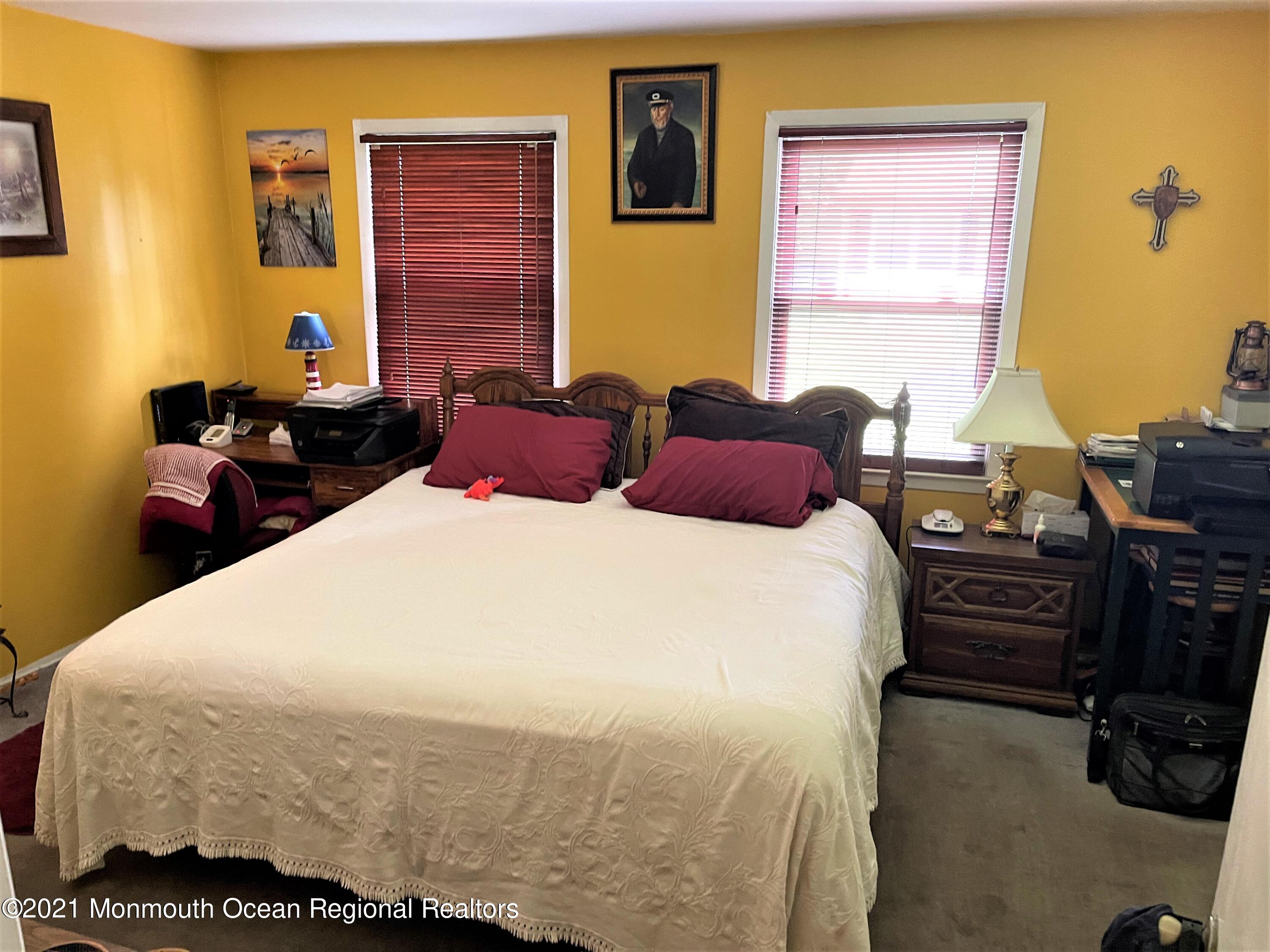 19 Augusta Road, Unit 73 Whiting, NJ 08759 - Photo 8 of 11 a bedroom with a bed and wooden floor