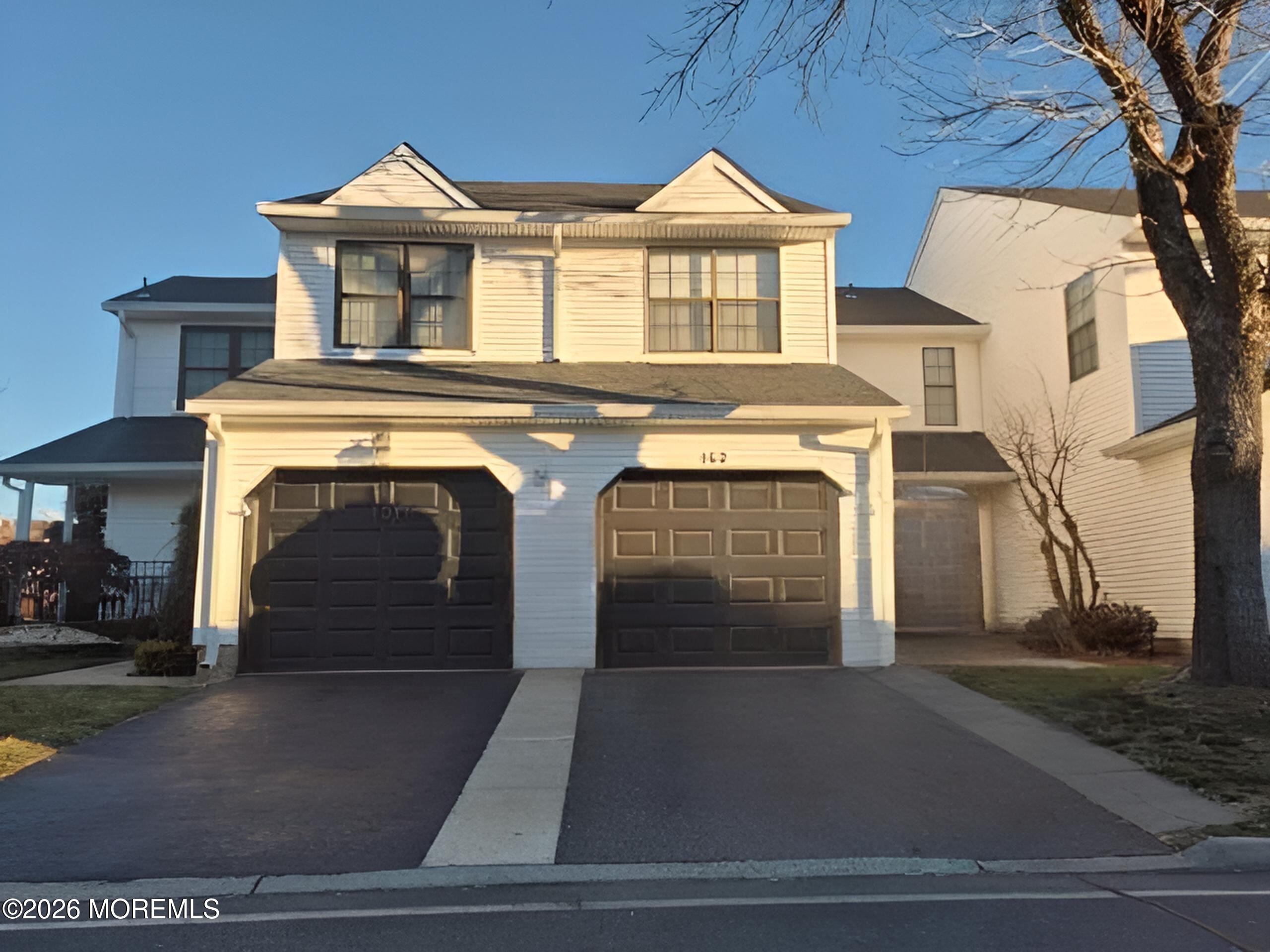 152 Chestnut Way, Unit 152 Englishtown, NJ 07726 - Photo 2 of 4 a front view of a house with a yard