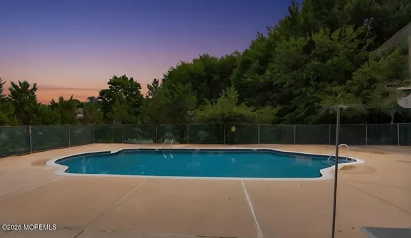 a view of a swimming pool with a yard