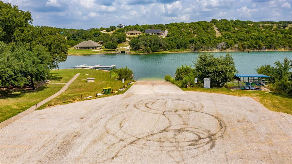 2280 Compass Way Bluff Dale, TX 76433 - Photo 19 of 40 front view of a house with a yard and lake view