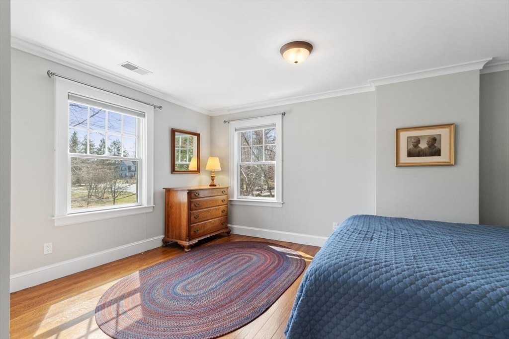 209 Waltham Street Lexington, MA 02421 - Photo 23 of 39 a bedroom with a bed and wooden floor