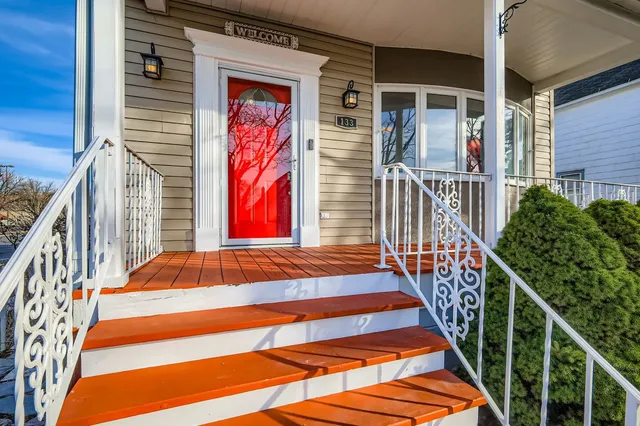 a front view of a house with a garden and plants