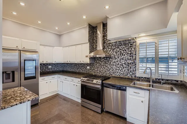 a kitchen with granite countertop a sink and cabinets