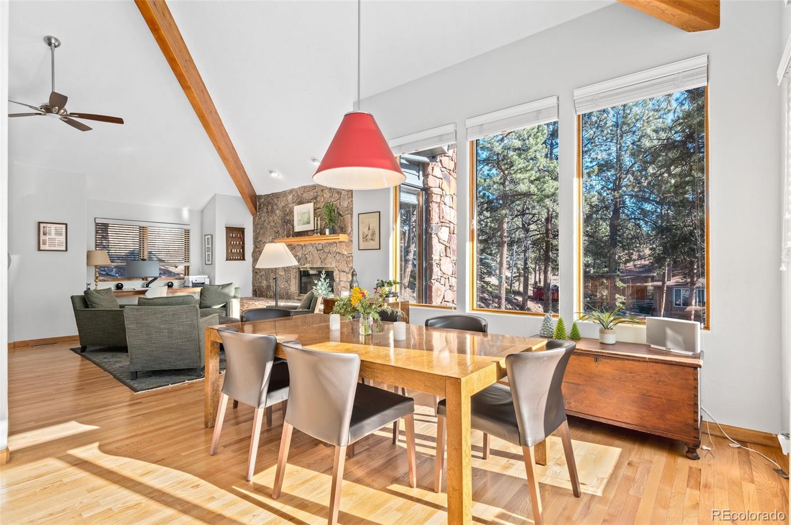 30754 Stratton Court Evergreen, CO 80439 - Photo 11 of 40 a view of a dining room with furniture window and wooden floor