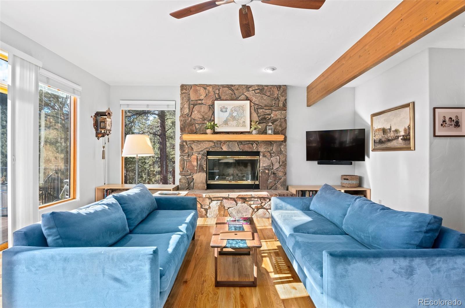 30754 Stratton Court Evergreen, CO 80439 - Photo 15 of 40 a living room with furniture and a fireplace