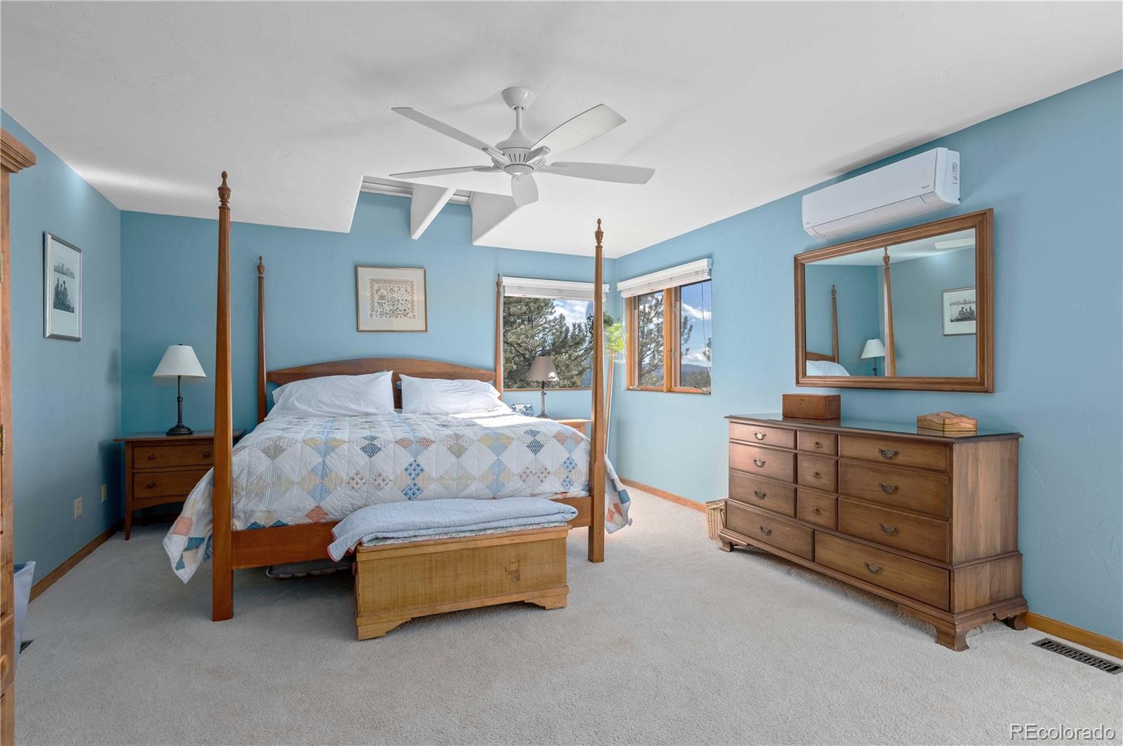 30754 Stratton Court Evergreen, CO 80439 - Photo 20 of 40 a bedroom with a bed and a dresser