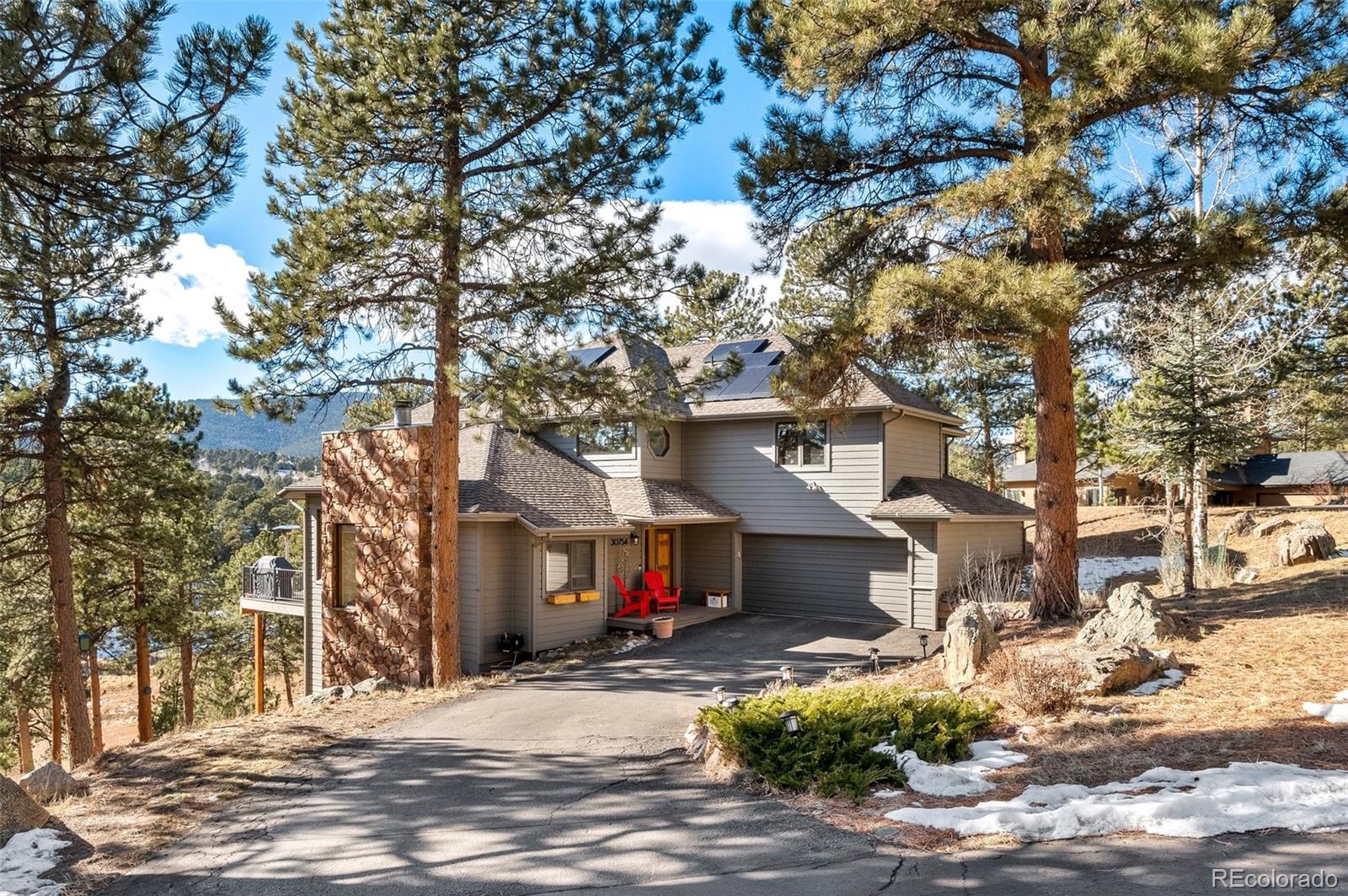 30754 Stratton Court Evergreen, CO 80439 - Photo 2 of 40 a view of a street with a tree in the background