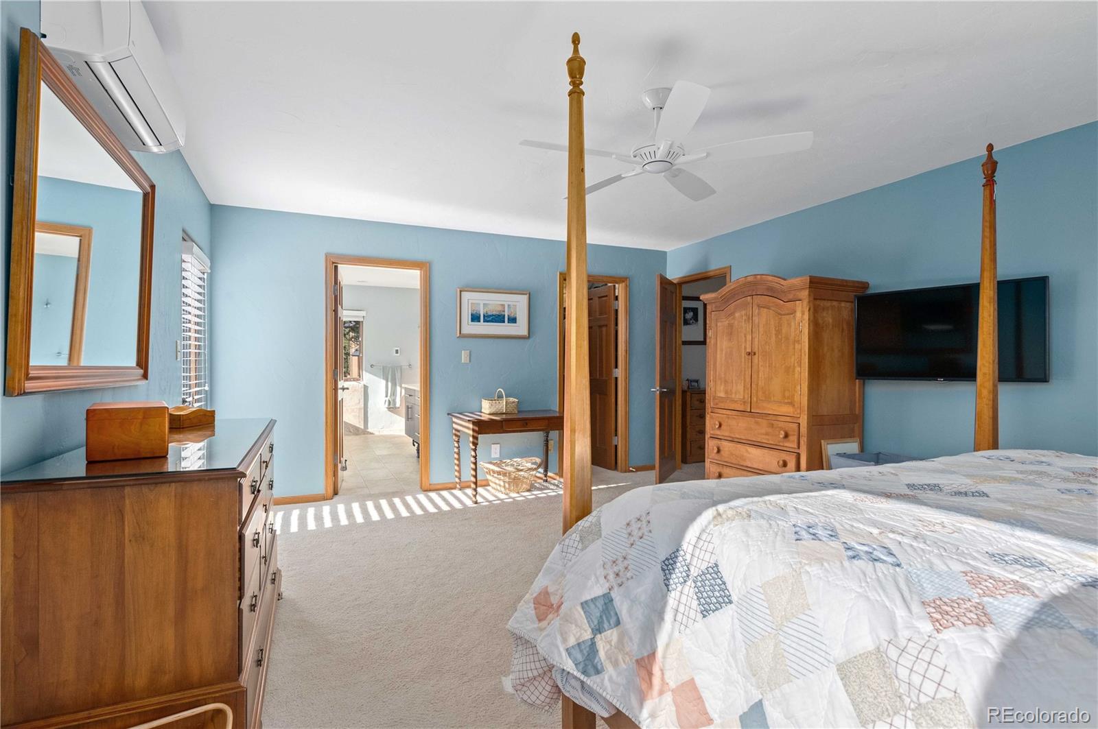 30754 Stratton Court Evergreen, CO 80439 - Photo 21 of 40 a bedroom with a bed and wooden floor