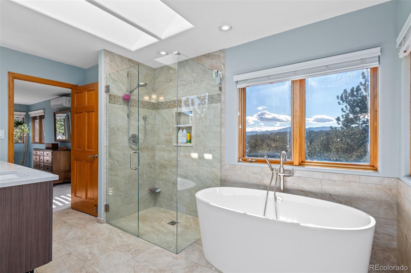 30754 Stratton Court Evergreen, CO 80439 - Photo 22 of 40 a white bath tub sitting next to a bathroom