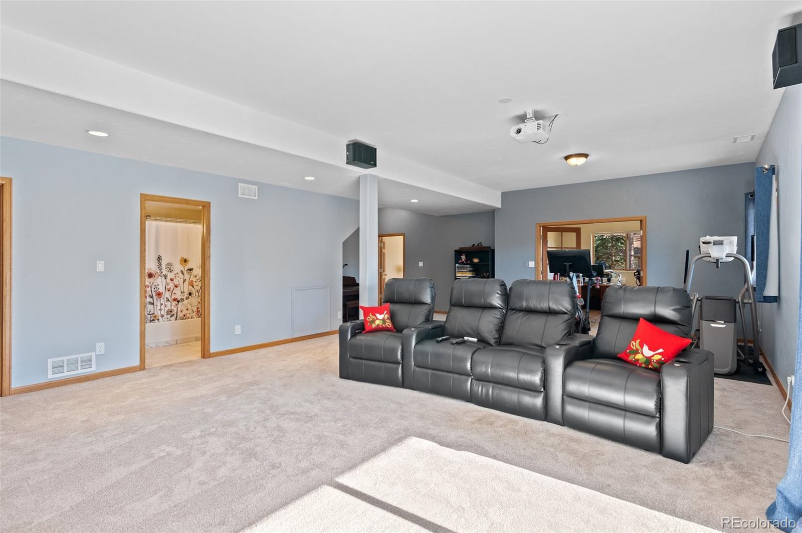 30754 Stratton Court Evergreen, CO 80439 - Photo 26 of 40 a living room with furniture and a flat screen tv