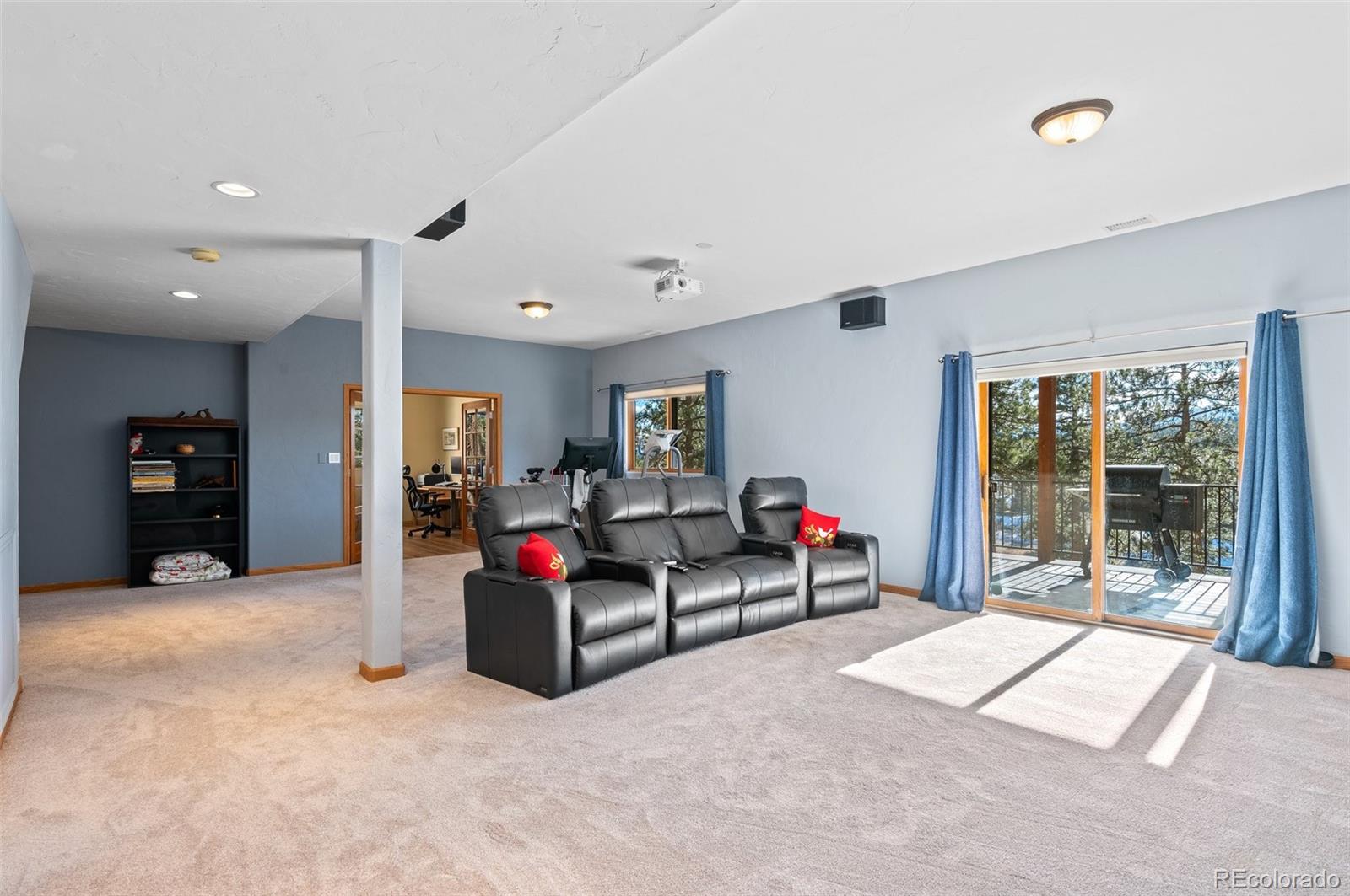 30754 Stratton Court Evergreen, CO 80439 - Photo 27 of 40 a living room with furniture and a flat screen tv