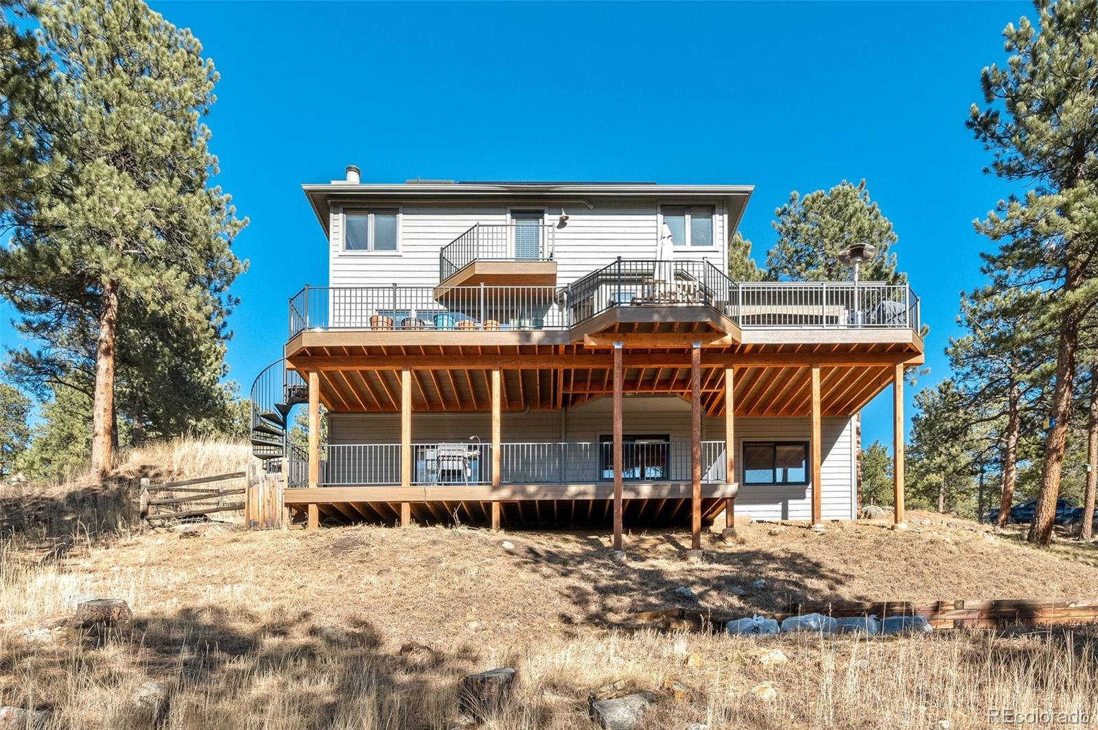 30754 Stratton Court Evergreen, CO 80439 - Photo 35 of 40 a view of a house with a yard