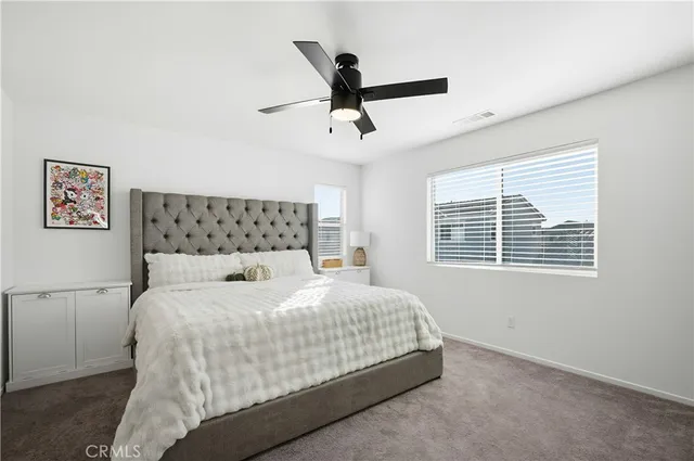 a bedroom with a bed and window