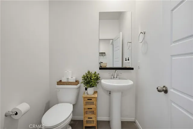 a bathroom with a sink toilet and mirror