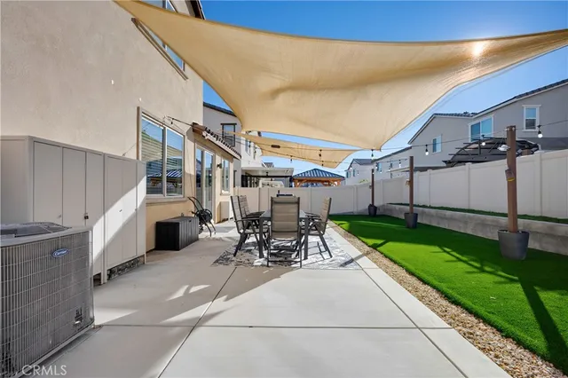 a view of a patio with table and chairs with wooden fence and plants