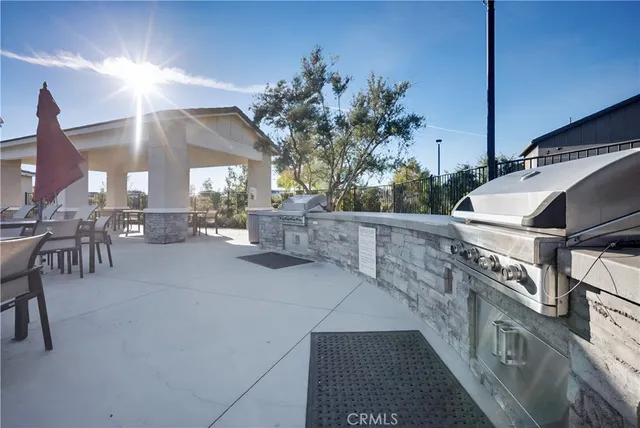 a view of a patio with couches and table with potted plants
