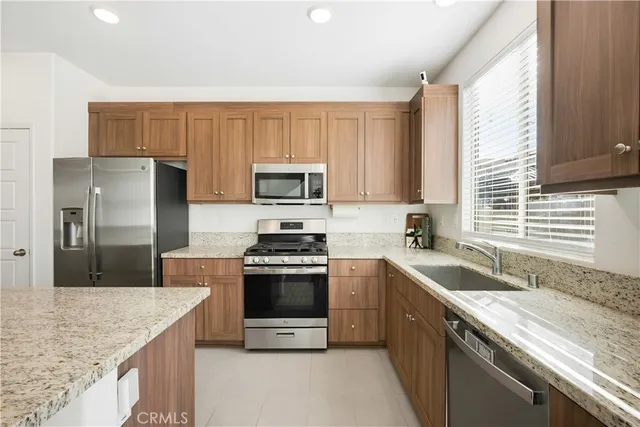 a kitchen with a sink stove top oven and refrigerator