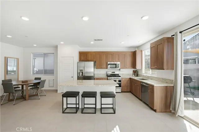 a large kitchen with lots of counter space and furniture