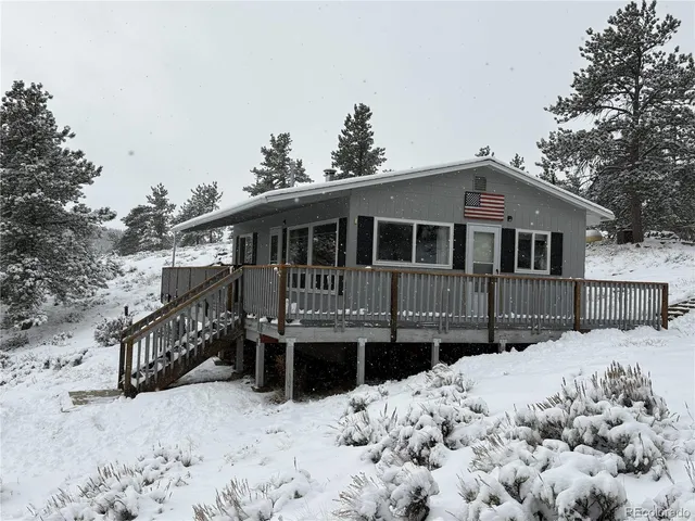 a front view of a house with a yard covered with snow in the house