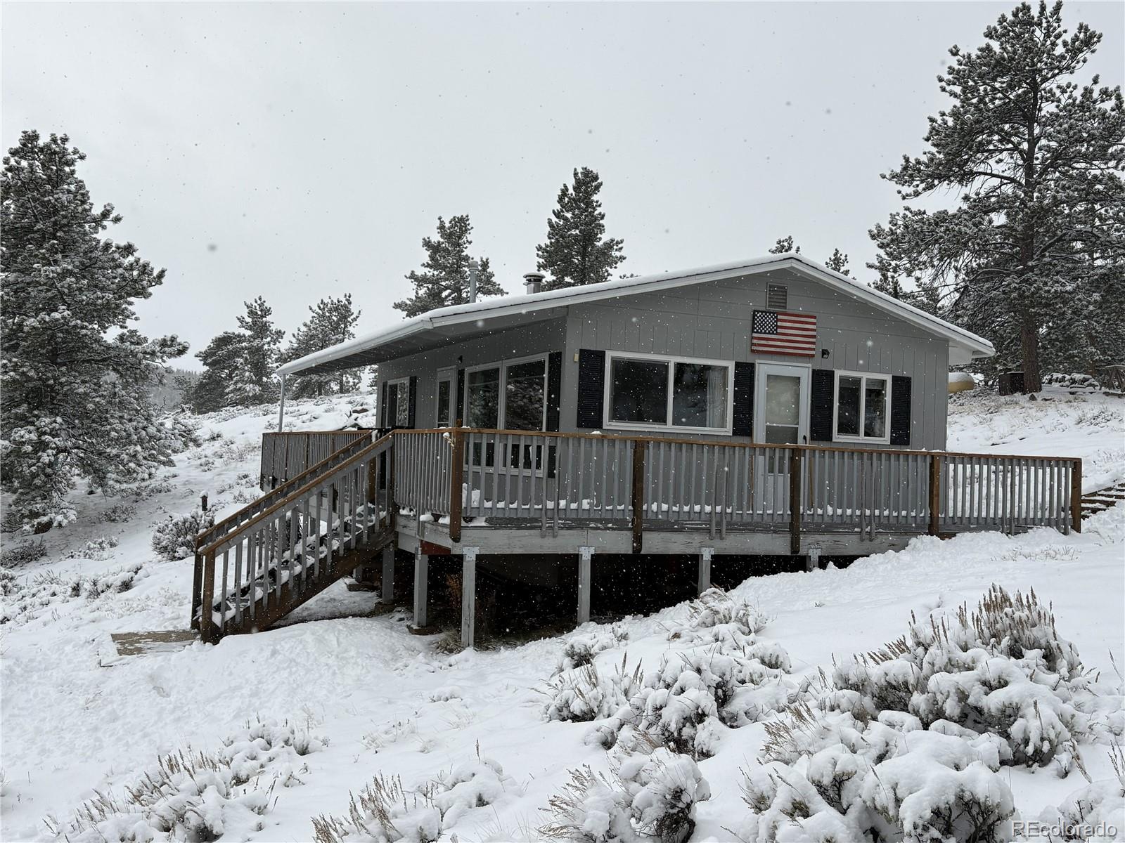 a front view of a house with a yard covered with snow in the house