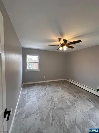 a view of a livingroom with a ceiling fan and window