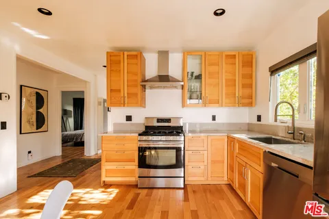a kitchen with a stove a sink and a refrigerator