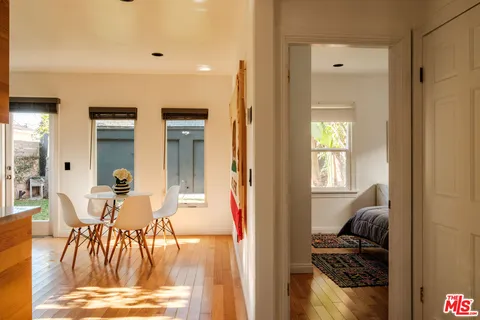a view of a livingroom with furniture and entryway wooden floor