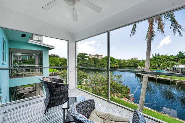 a view of a balcony with lake view and a couches
