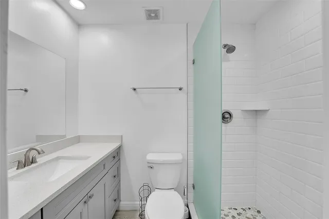 a bathroom with a sink toilet and shower