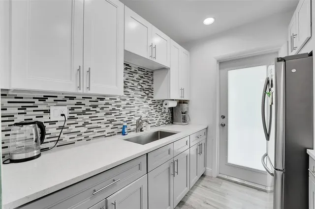 a kitchen with a sink and refrigerator