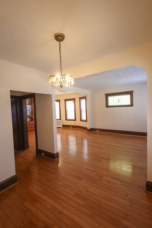 17 Maple Avenue, Unit 1 Everett, MA 02149 - Photo 2 of 8 a view of a room with wooden floor chandelier and windows