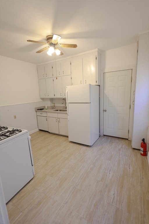 17 Maple Avenue, Unit 1 Everett, MA 02149 - Photo 7 of 8 a room with lot of cabinets and washer dryer