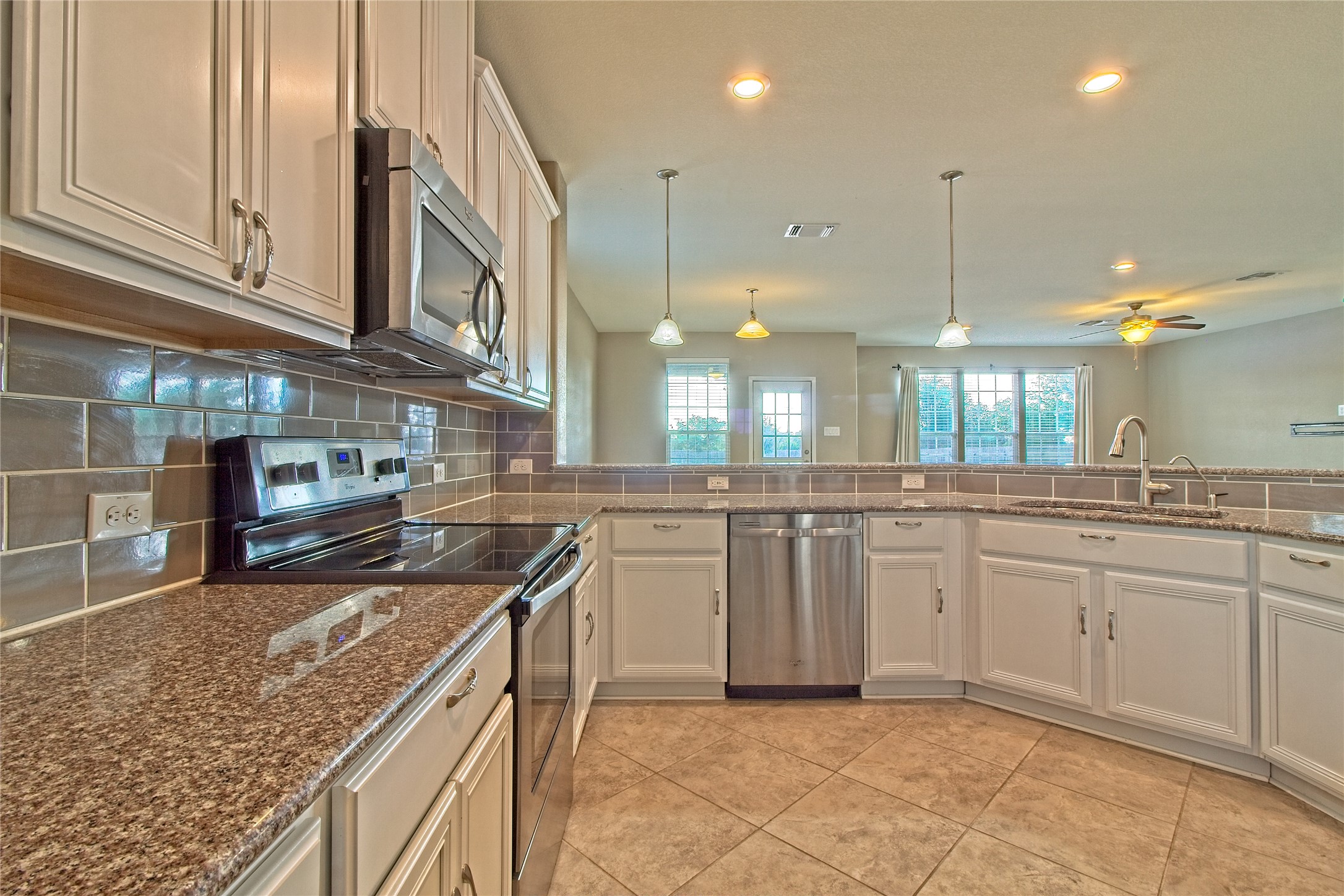 31443 Kingsway Road Georgetown, TX 78628 - Photo 12 of 40 Granite counters and stainless steel appliances adorn this functional kitchen.